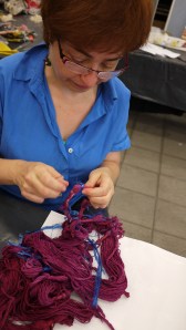 Liliana Chwistek removes binding from her warp, dyed with Brazilwood.