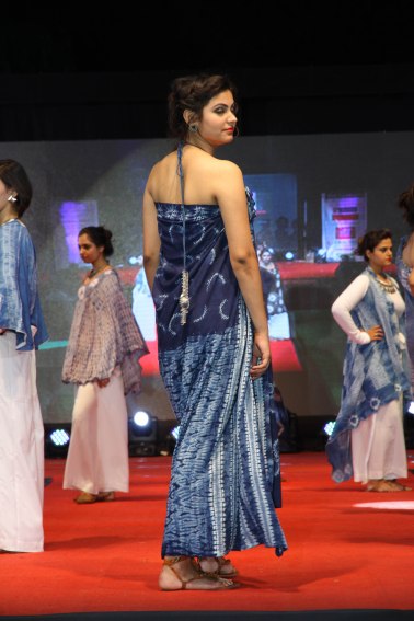 Combining multiple forms of stitch resist, Dr. Reena Bhatia created a garment in shade of indigo blue that shift as the model turns.