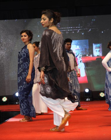 The back detail of Mrs. Jenifer Homi's suggests coral shifting in the sea.